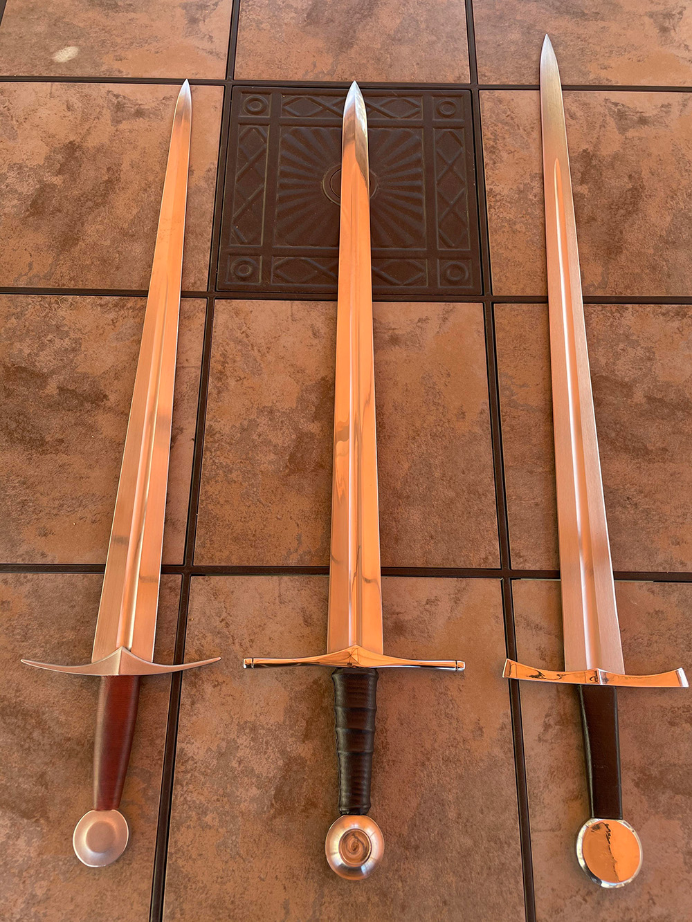 3 arming swords side by side